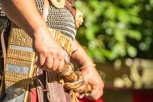 detail of the hands of a centurion of the roman legion with the baton of command in a party of historical recollection. photo