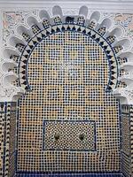 A fountain adorned with intricate Moroccan Zellige tiles crafted geometric patterns in vibrant colors and forms, reflecting the exceptional skill of Moroccan craftsmen who mastered their craft photo