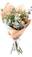 Bouquet of roses, eucalyptus, and greenery wrapped in paper for weddings and celebrations photo