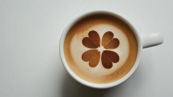 Cup of coffee with four-leaf clover latte art, good luck and celebrating St. Patrick's Day photo
