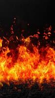Raging fire with intense flames a black background, showcasing powerful energy photo
