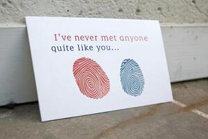 Minimalist greeting card with red and blue fingerprint patterns and romantic text. Love and identity concept photo