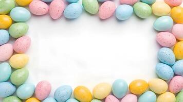 Flat lay composition of colorful speckled Easter eggs forming a frame on a white background. Holiday mockup with copy space photo