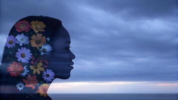Double exposure of a woman with floral patterns against a cloudy sky. Serenity and self-reflection concept photo