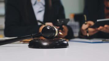 Judge's gavel on a desk with two business people video