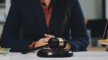 A judge's gavel sits on a table next to a stack of money video