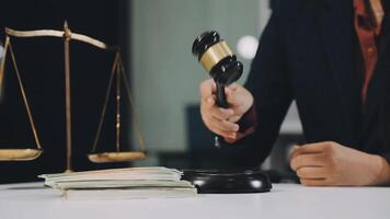 A judge holding a gavel and money on a desk video