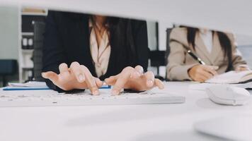 Two businesswomen working on a computer video