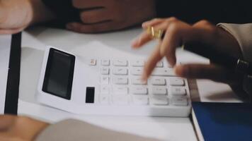 A person using a calculator to calculate a number video