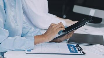 A person is using a tablet while sitting at a desk video