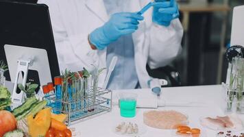 A man in a lab coat is working on a computer video