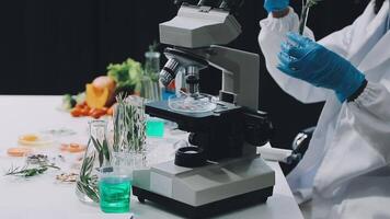 A person in a lab coat is looking at a microscope video