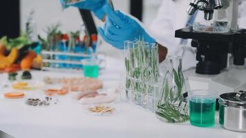 A person in a lab coat is holding a glass video
