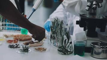 A person in a lab coat is holding a glass video