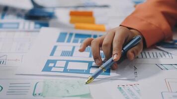 A person is working on a project with blue and white papers video