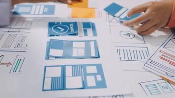 A person is working on a design project with paper and blue paper video