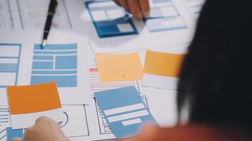 A person is working on a design project with paper and pencils video