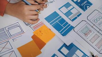 A person is working on a design project with a pen and paper video