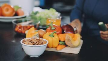 A woman is preparing food on a table with vegetables and nuts video