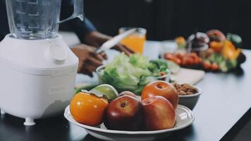 A person is preparing food in front of a blender video