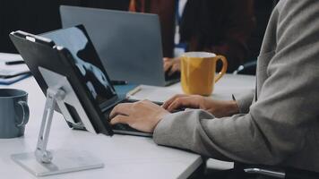 A person typing on a laptop at a desk video