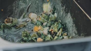 A close up of a trash can with food in it video