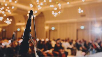 Microphone in front of a large audience at a conference video