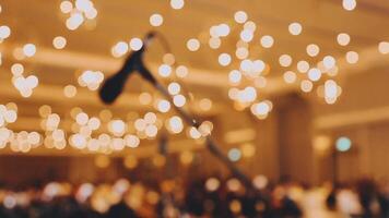 A microphone is in front of a large room with lights video