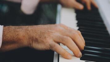 A close up of a person's hands playing the piano video