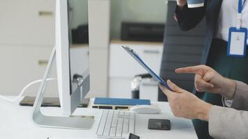 A man is using a tablet computer while sitting at a desk video