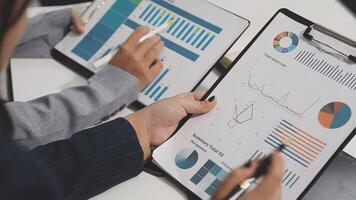 Business people using a clipboard to show graphs and charts video