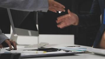 Two business people shaking hands at a desk video