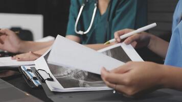 Two doctors are working on a paper document video