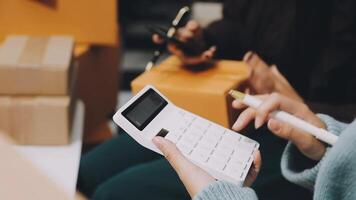 A person holding a calculator and a box of boxes video