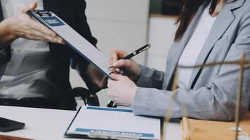 A man and woman are signing papers at a desk video