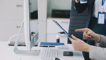 A man is using a tablet computer while sitting at a desk video