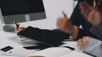 Business people sitting at a desk with a laptop and pen video