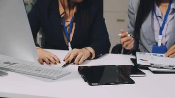 Two businesswomen working on a computer at a desk video
