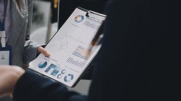 Business people holding a clipboard with graphs and charts video