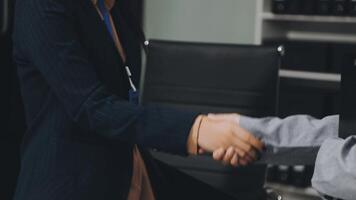 A business person shaking hands with another person video