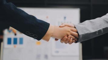 Two business people shaking hands in front of a whiteboard video