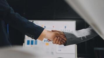 Two business people shaking hands in front of a whiteboard video