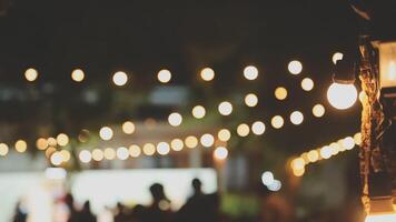 A group of people are sitting around a table with lights video