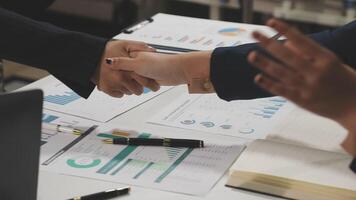 Business people shaking hands over a table with papers video