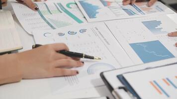 Business people working on graphs and papers video