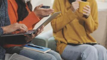 Three people sitting on a couch with laptops video