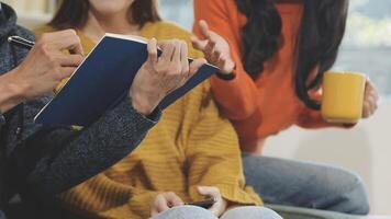 A group of people sitting on a couch with a notebook video