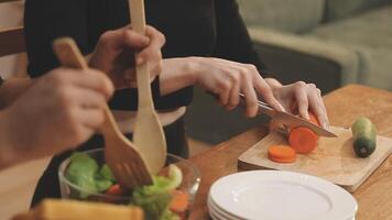 A person cutting vegetables with a knife and fork video