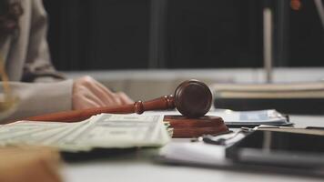 A judge's gavel and money on a desk video