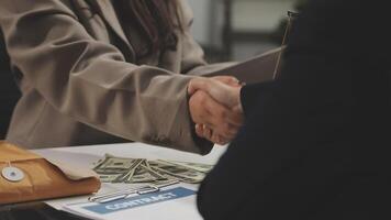 A business person shaking hands with another person video